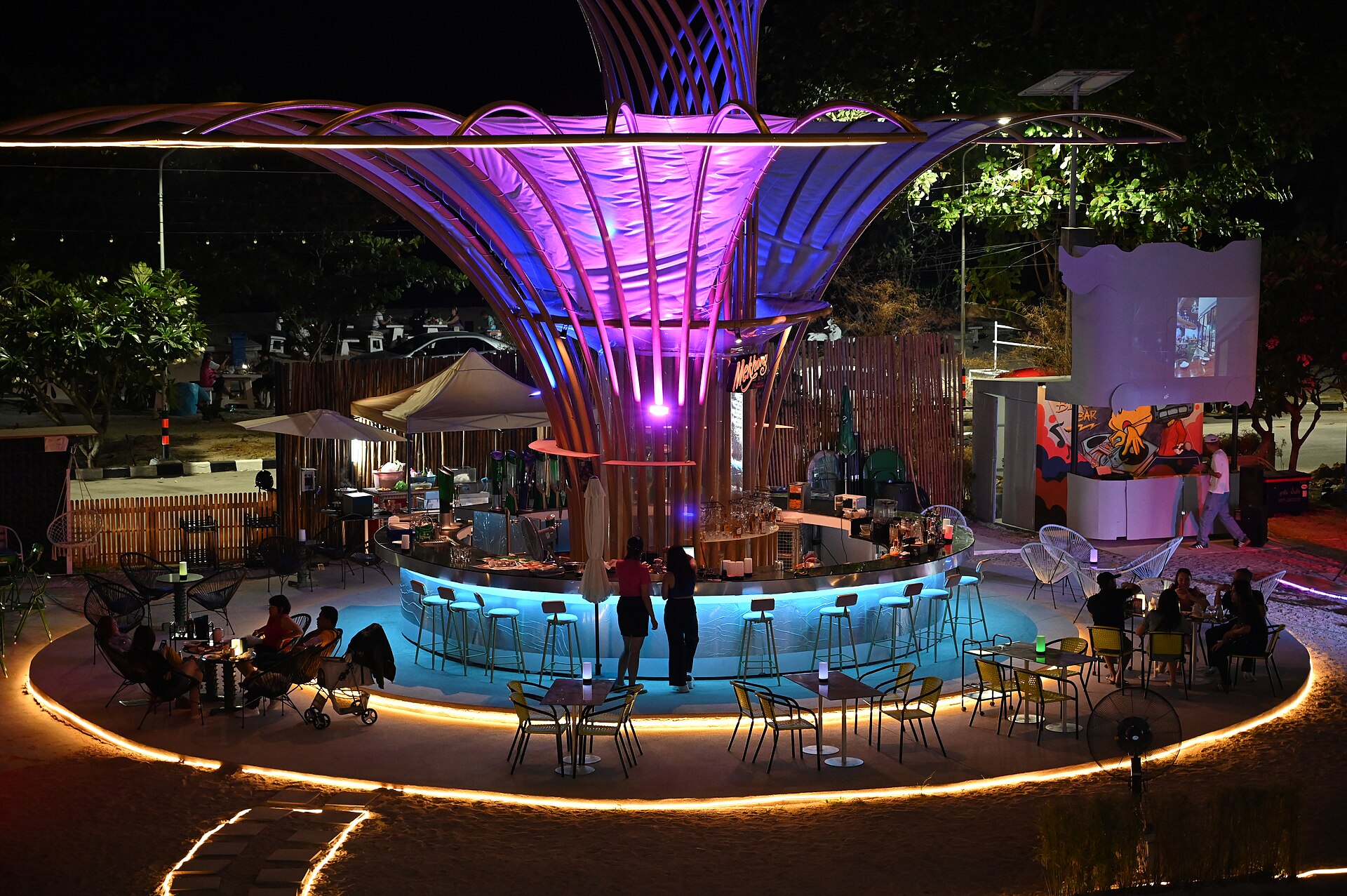 An outdoor bar lit up at night